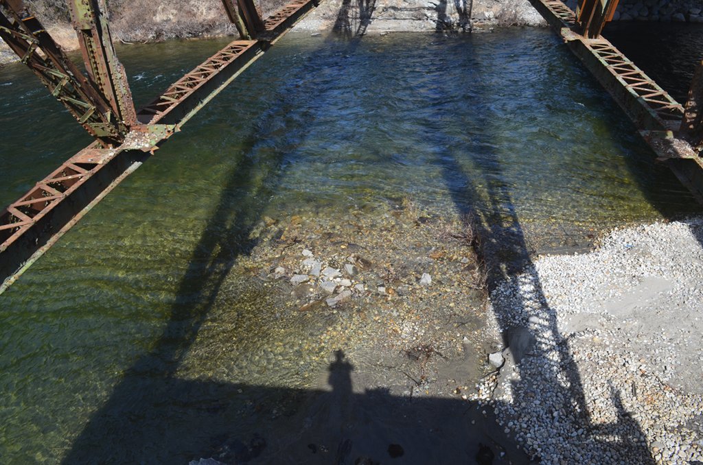 Looking into the river below the bridge.